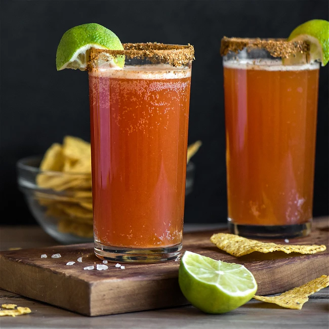 Spicy michelada with Tajin rim tomato juice and cold Mexican beer