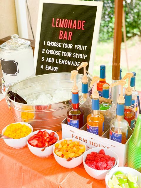 backyard lemonade bar with berries mint and citrus slices