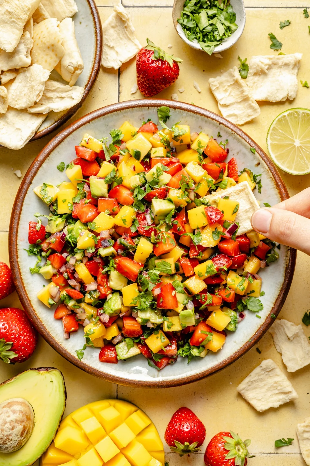 Mango salsa served in a bowl with tortilla chips alongside