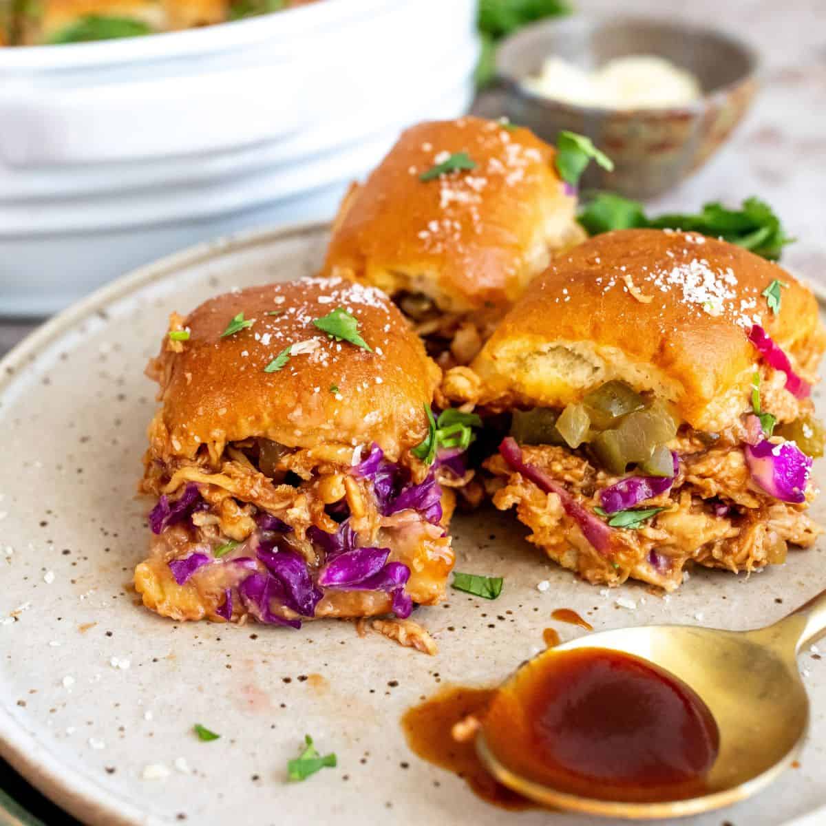 BBQ chicken sliders with coleslaw on a backyard party tray