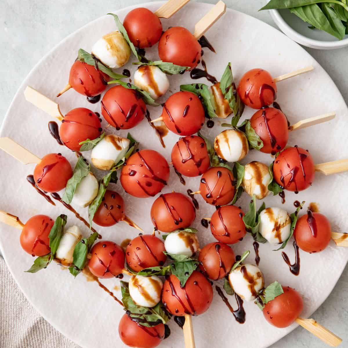 caprese skewers with tomatoes mozzarella basil and balsamic glaze