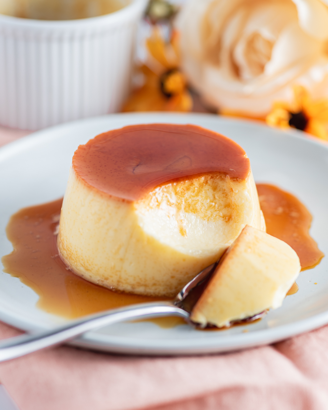Classic flan with amber caramel sauce on a white plate