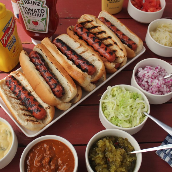 grilled hot dog bar with toppings for a backyard party