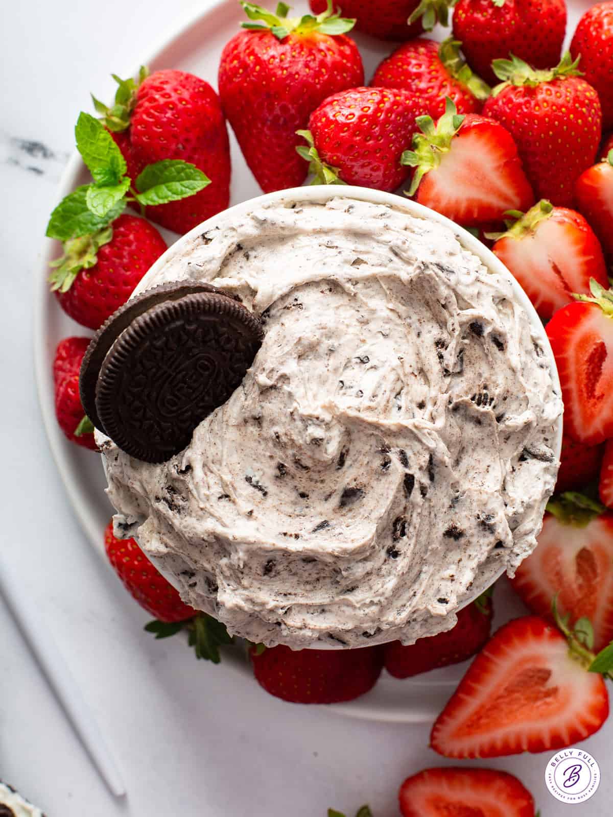 Oreo dessert dip with cookies and strawberries on a party table