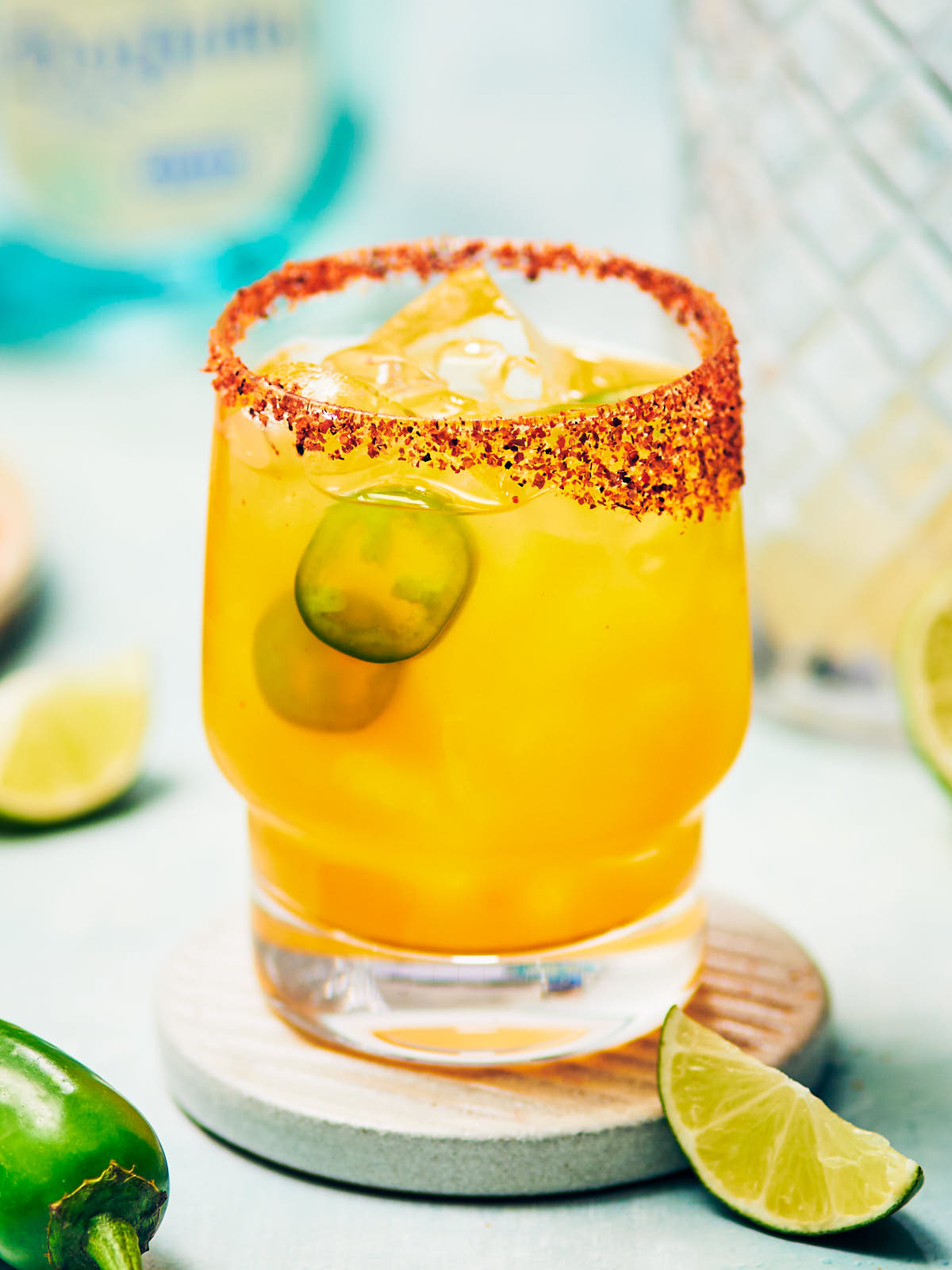 Mango jalapeno margarita close up with Tajin rim and fresh garnish