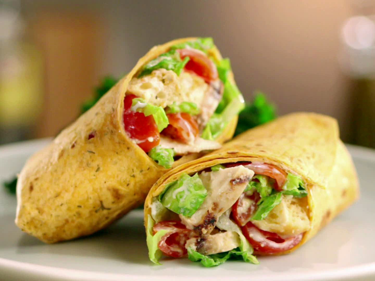 Grilled chicken Caesar wraps cut in half