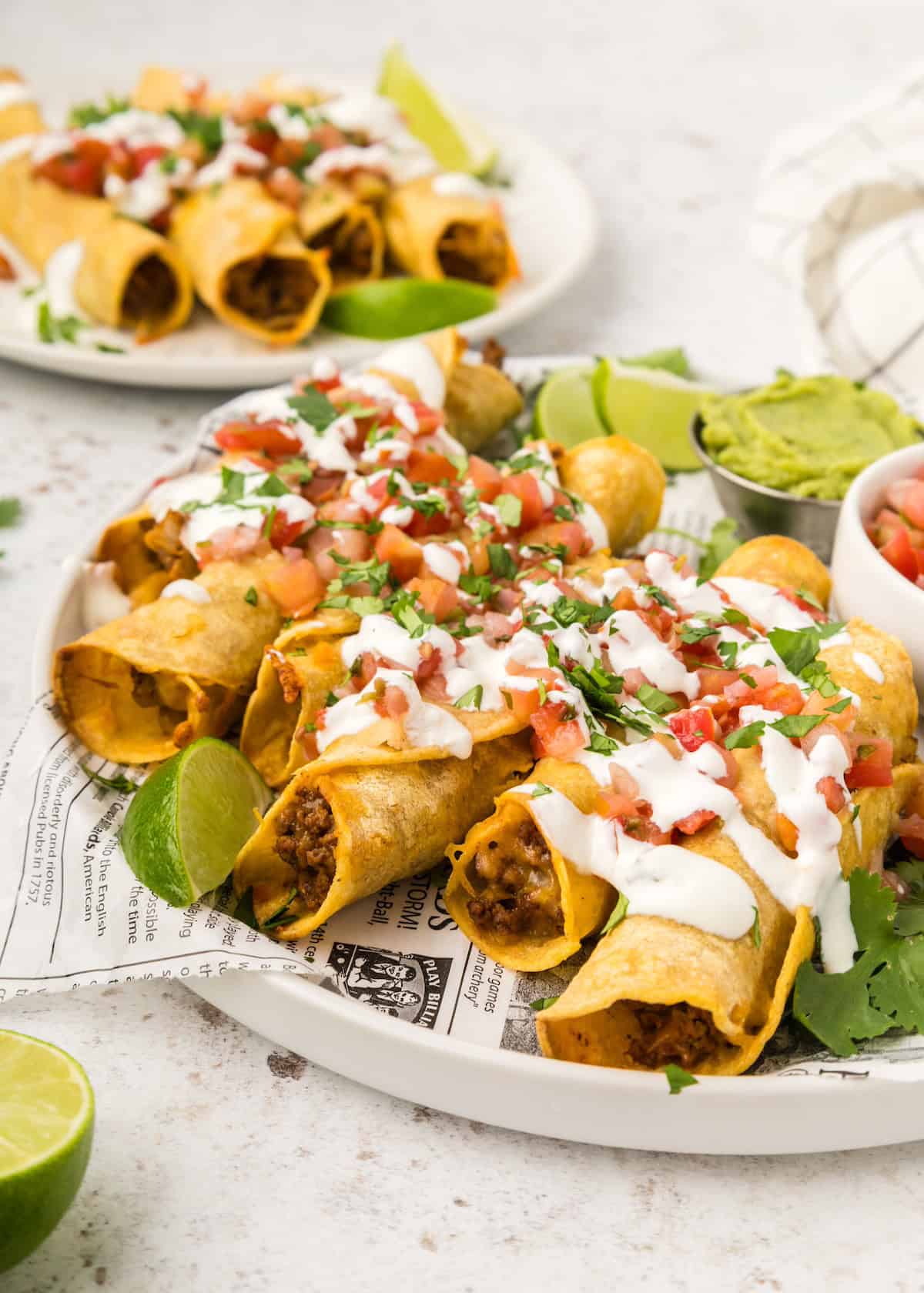 Golden baked beef taquitos on a baking sheet fresh from the oven