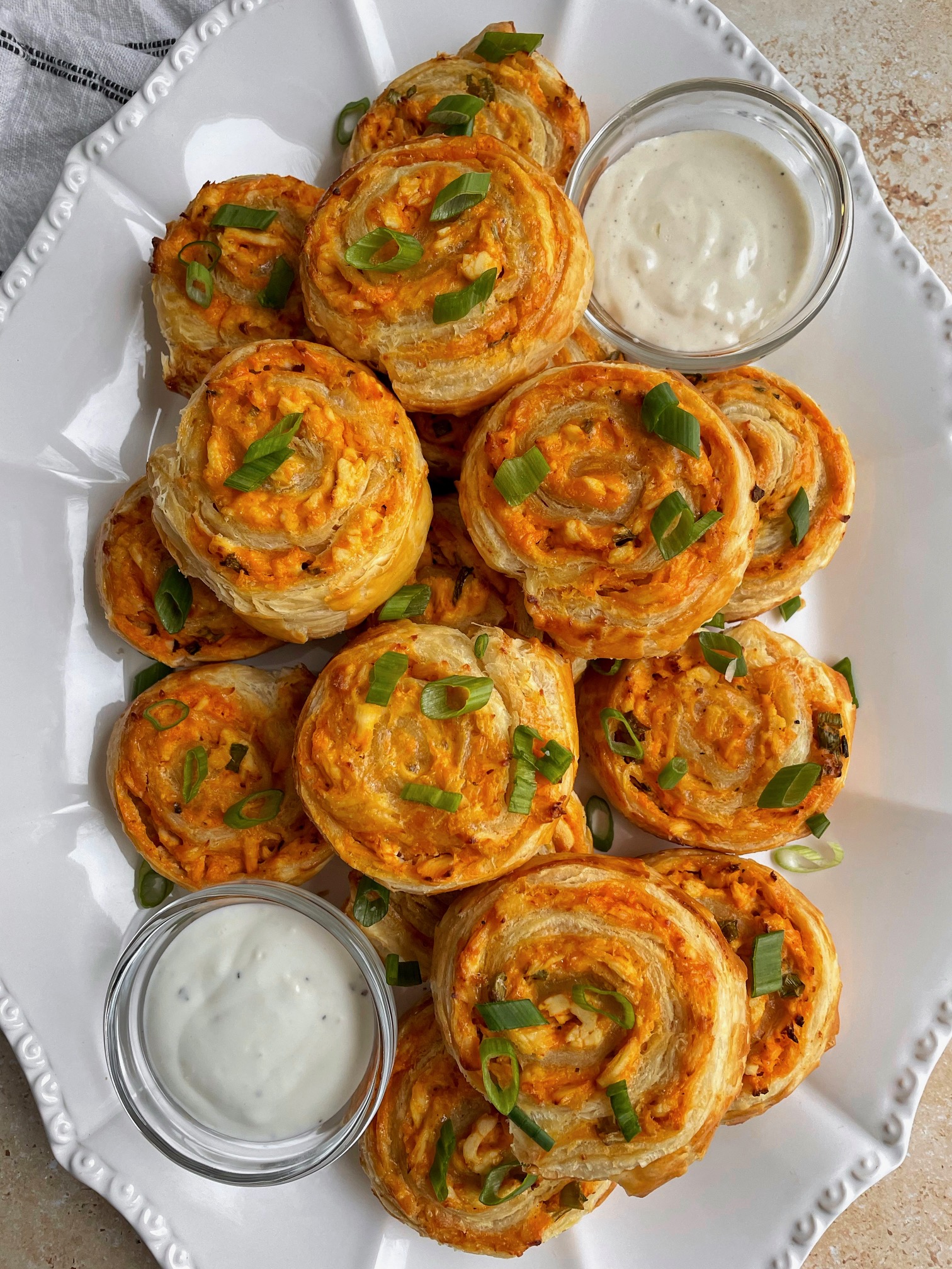 buffalo chicken pinwheels sliced on a party platter