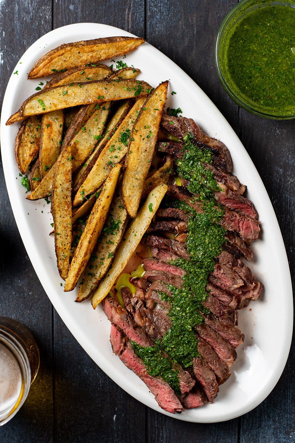 Sliced grilled steak with chimichurri sauce