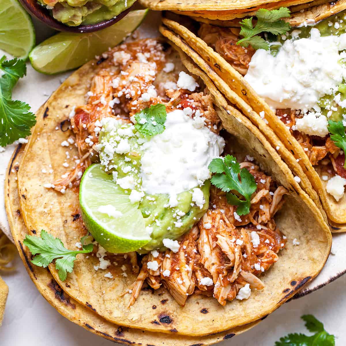 Crockpot chicken tacos with shredded chicken and toppings