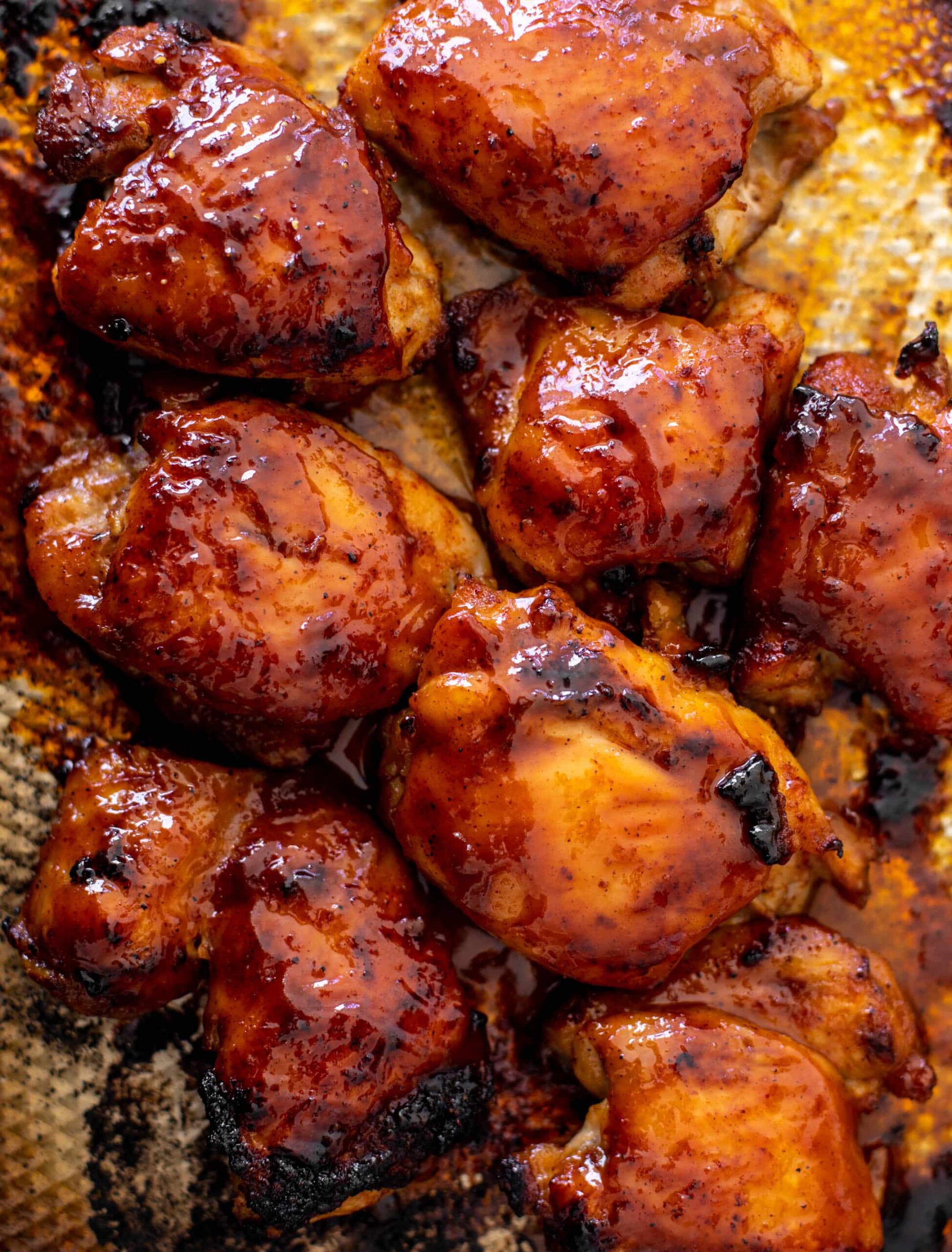 Honey BBQ chicken thighs on a summer grill