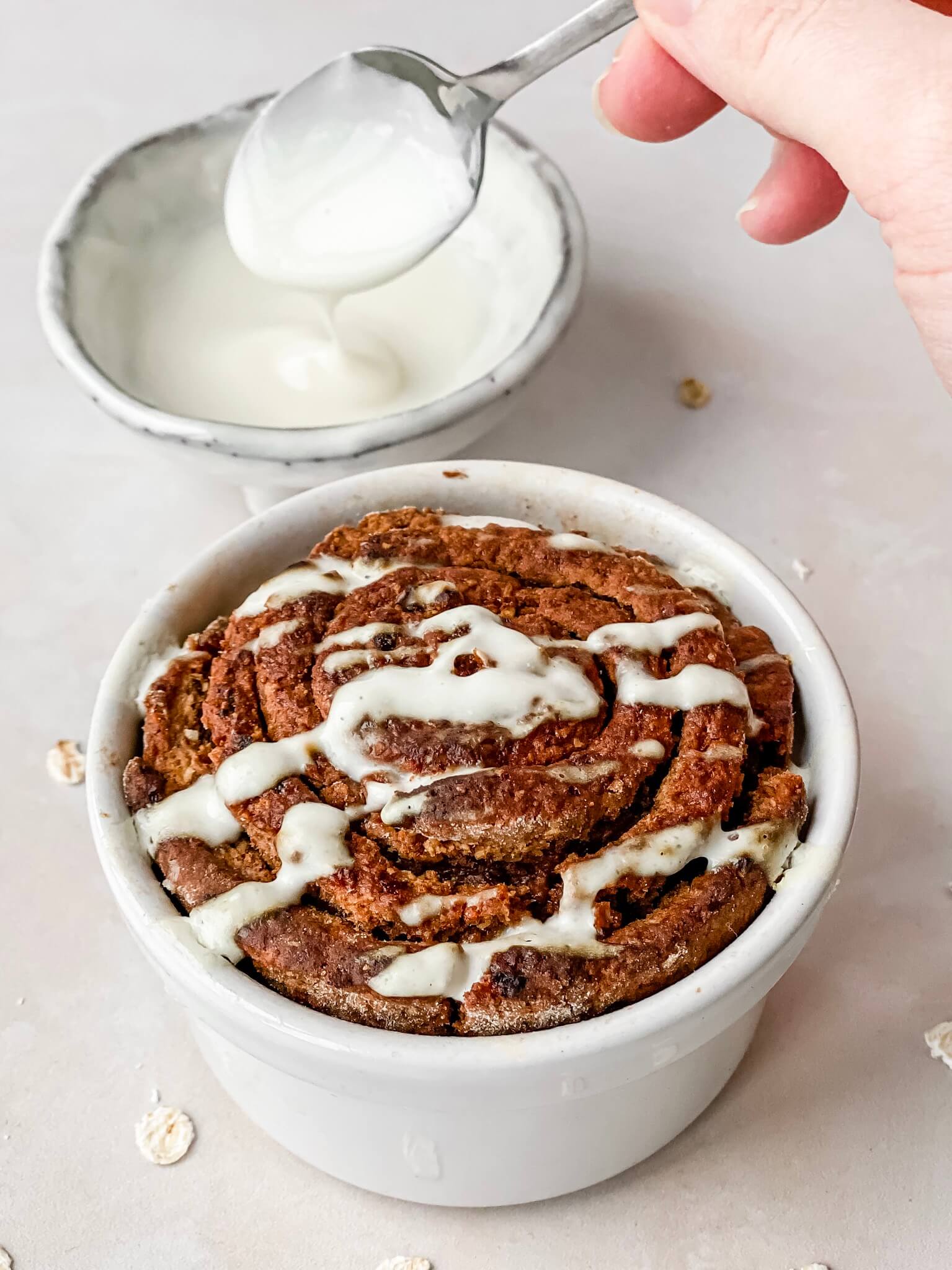 Cinnamon roll baked oats with cream cheese glaze on top
