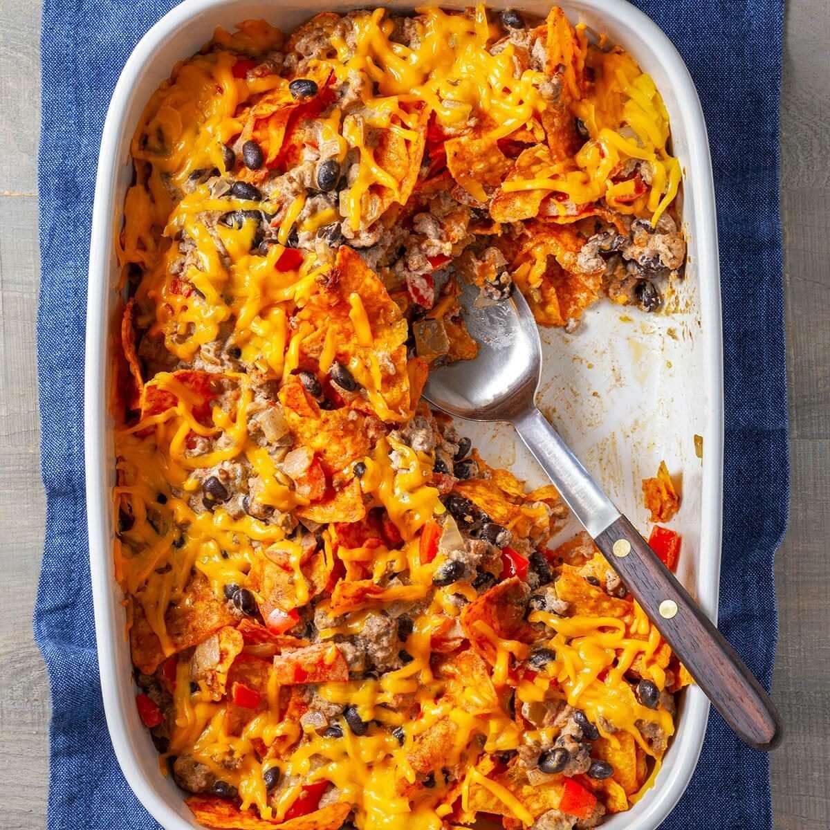 Classic cheesy Mexican beef casserole bubbling from the oven