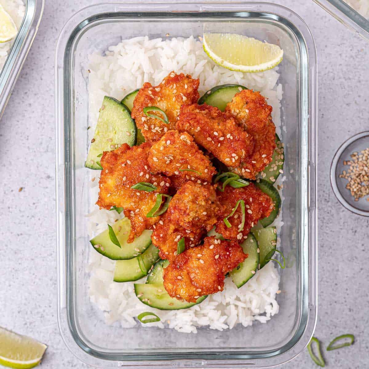 Honey sriracha chicken meal prep bowls lined up in containers