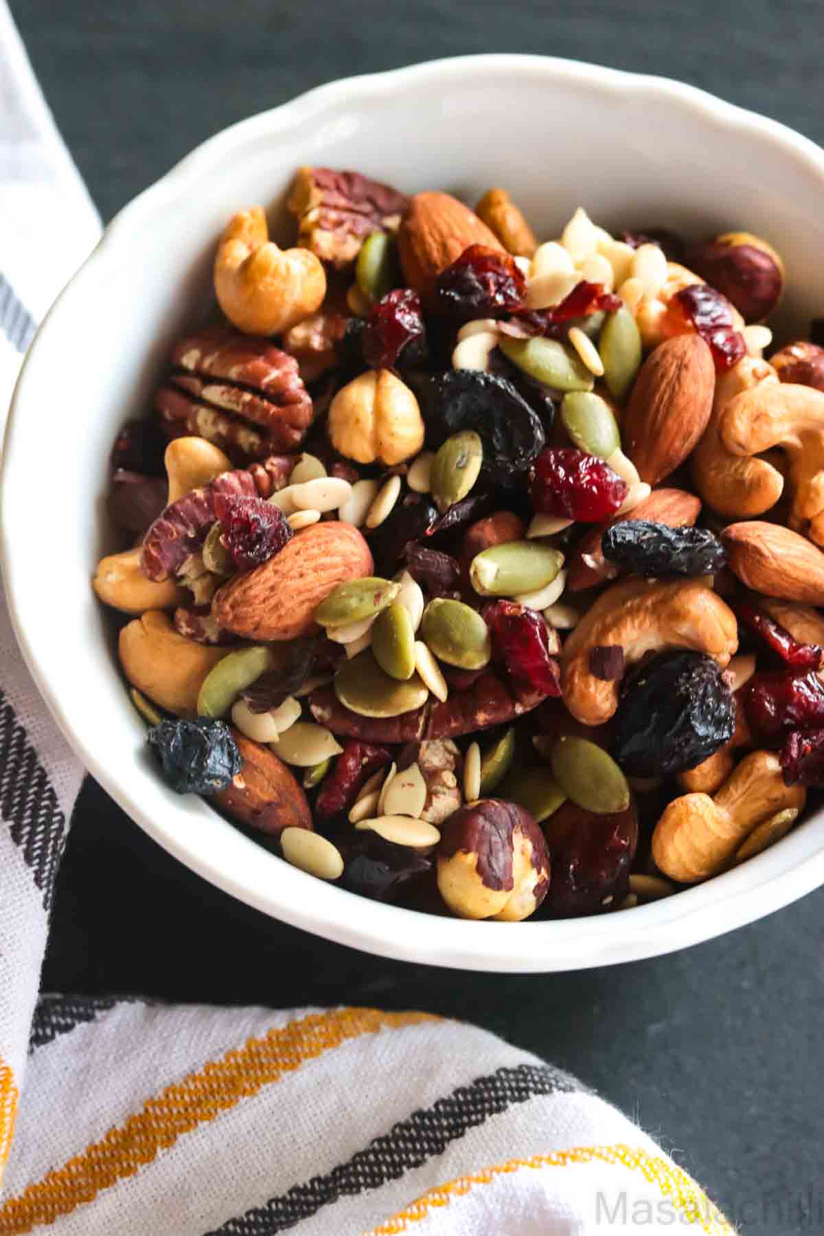 Healthy nut and seed trail mix with almonds walnuts pumpkin seeds sunflower seeds and dried fruit