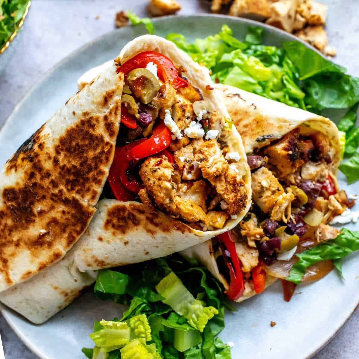 Mediterranean chicken wraps with hummus cucumber tomatoes and feta