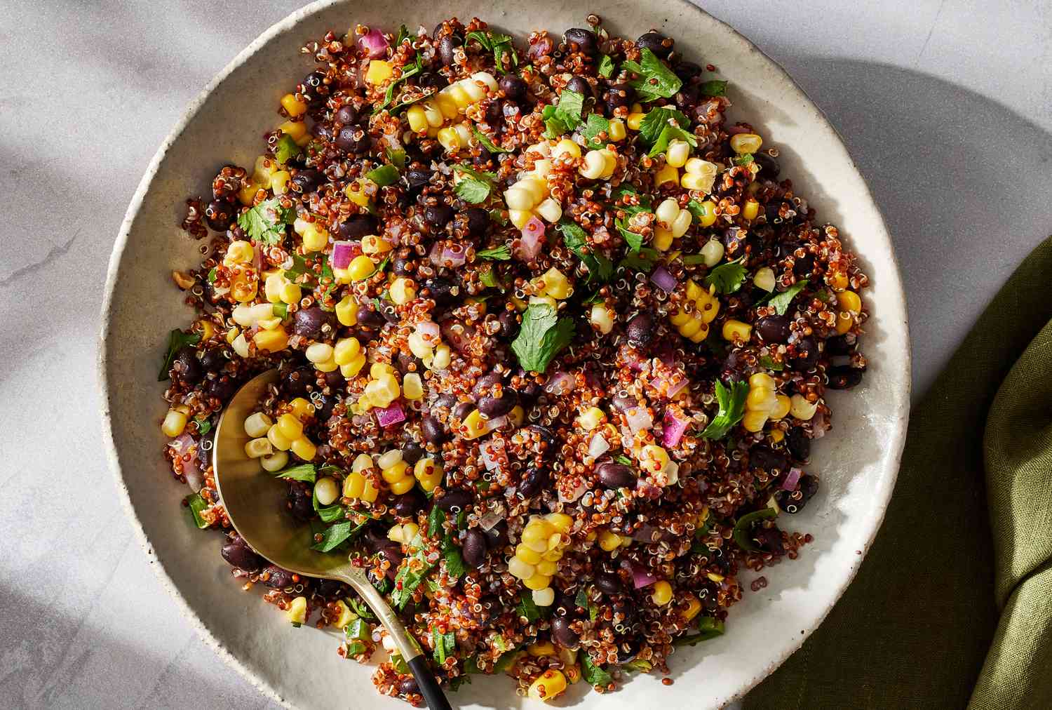 Corn black bean quinoa bowls with avocado tomatoes and cilantro lime dressing