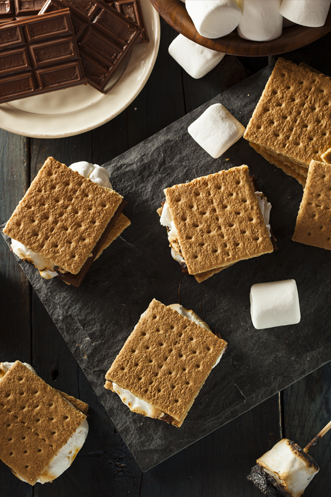 Classic campfire s'mores with toasted marshmallows melted chocolate and graham crackers