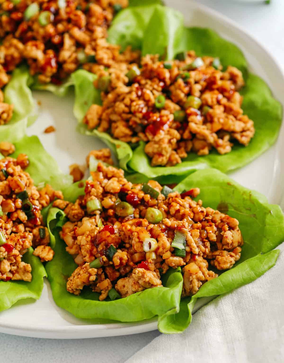 Healthy turkey lettuce wraps with carrots cucumber and sauce
