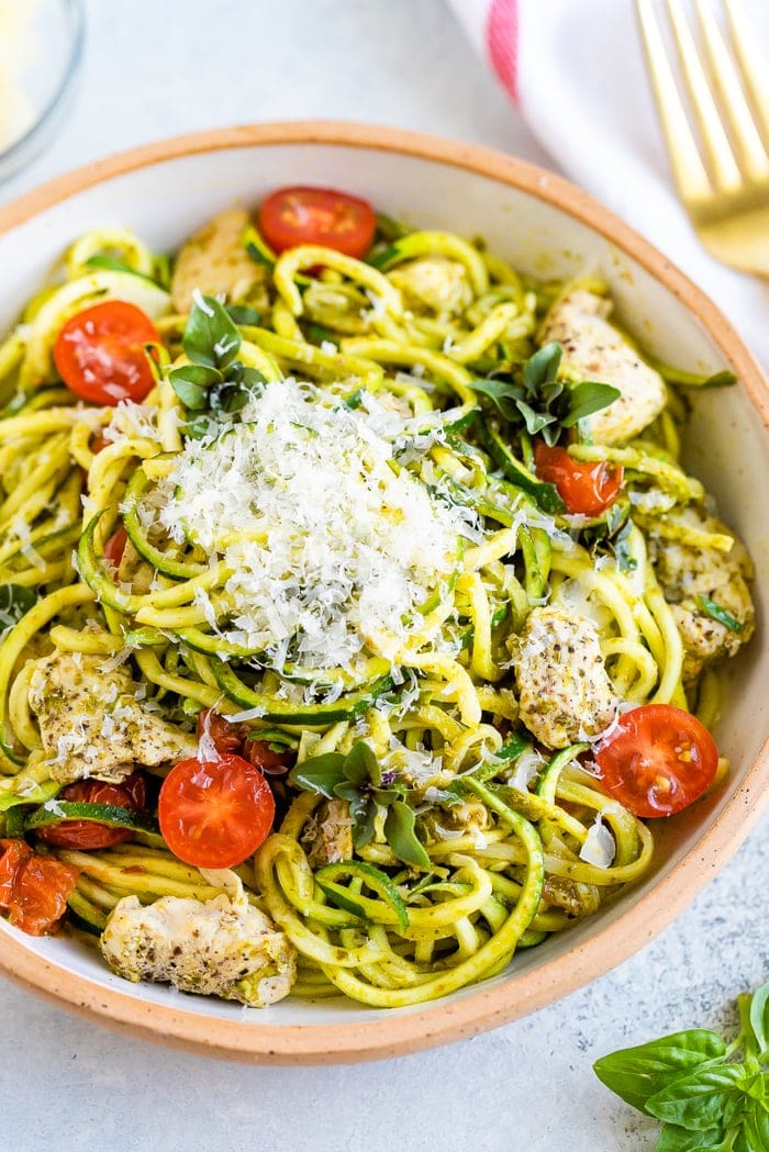 Zucchini noodle pesto bowls with tomatoes chickpeas and grilled chicken