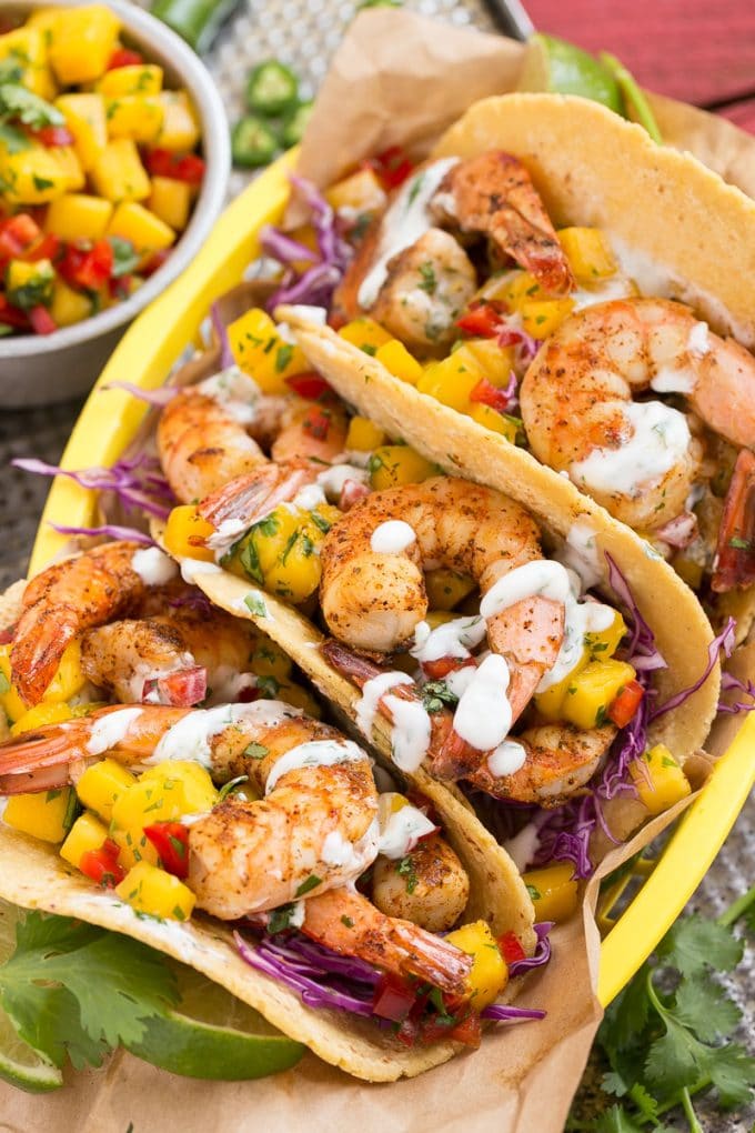 Shrimp mango tacos with cabbage avocado and lime