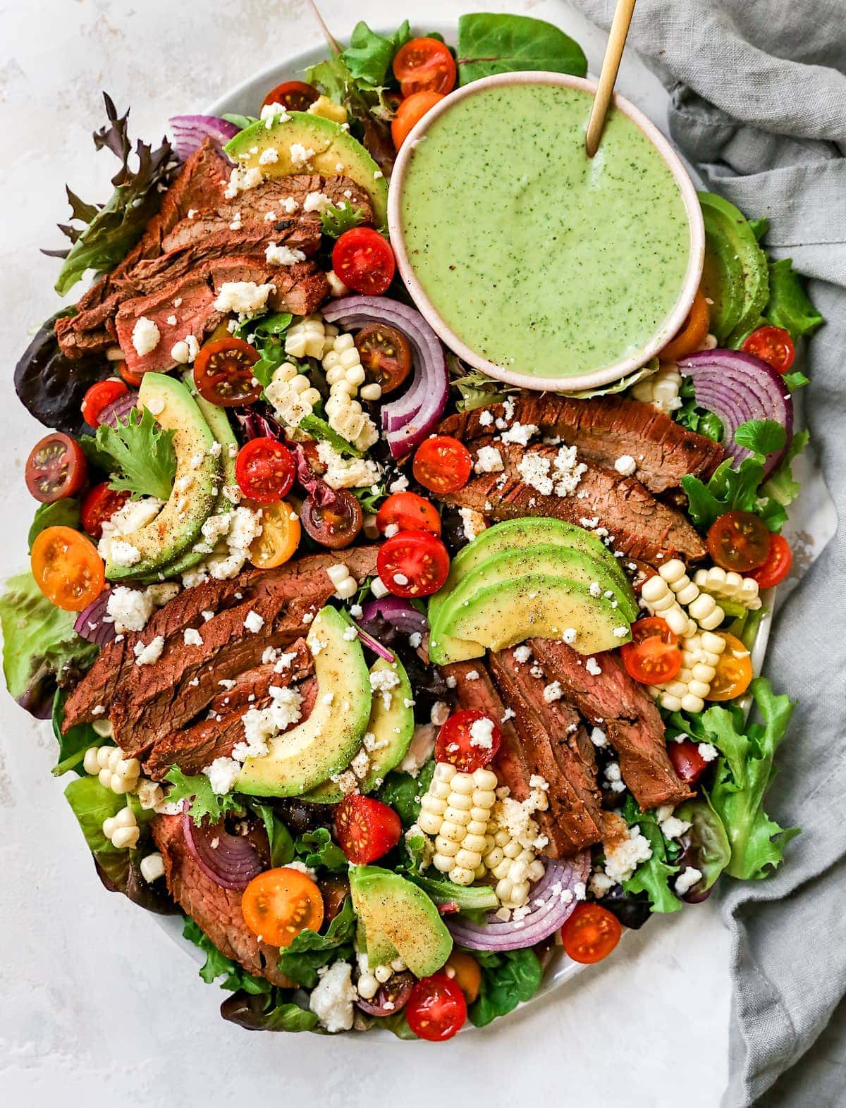 Grilled steak summer salad with cucumber tomatoes avocado and feta