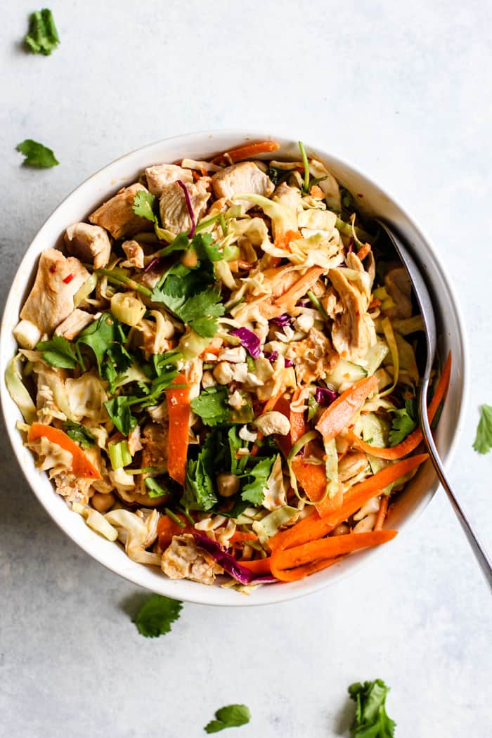Thai peanut chicken salad with cabbage carrots cucumber and herbs